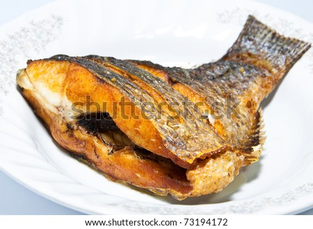Golden fired fish in a plate