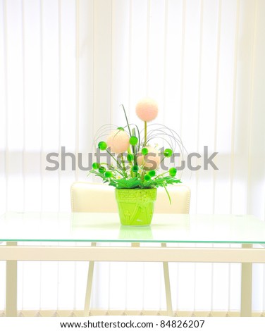 Artificial flower in vase on mirror desk