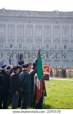 Italian war veterans celebrate troops returning from Iraq. Royal palace on the background