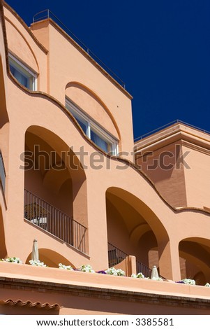 Summer house or hotel in Capri, Italy. View from below against deep blue sky.