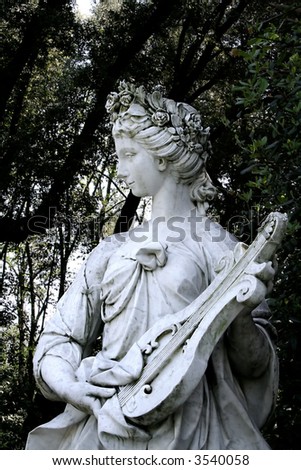 A classic statue representing the Nymph of Music. In a public park in Italy.