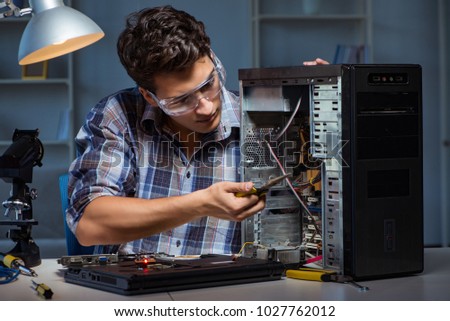 Man repairing computer desktop with pliers