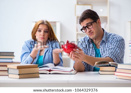 Two students checking savings to pay for education