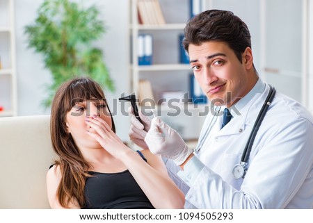Doctor checking patients ear during medical examination