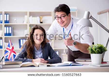 Teacher explaining to student at language training
