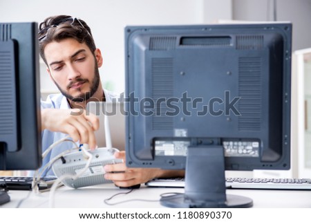 IT technician looking at IT equipment