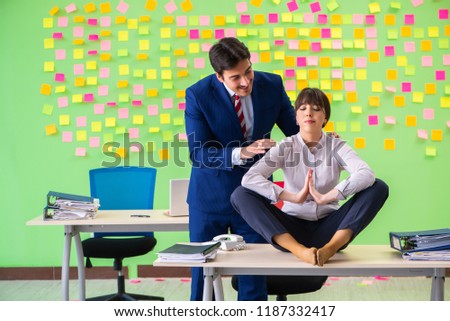 Man and woman in the office with many conflicting priorities in