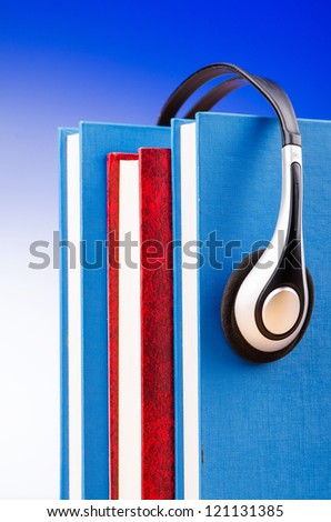 Concept of audio books with earphones on white