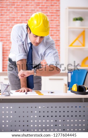 Construction supervisor working on blueprints