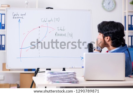 Busy businessman explaining business charts
