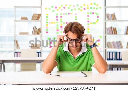 Student struggling at the exam in classroom