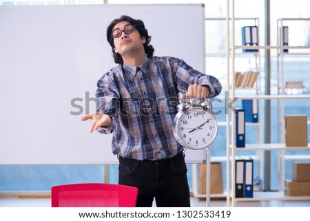 Funny male teacher in front of whiteboard