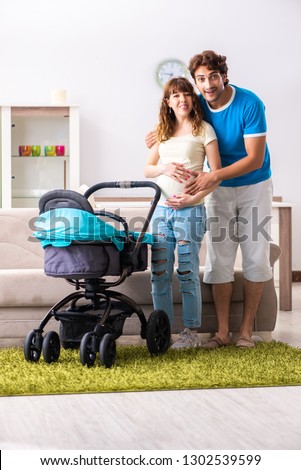 Young parents with baby expecting new arrival