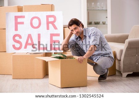 Young man offering home for sale and moving out