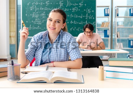 Young students taking the math exam in classroom
