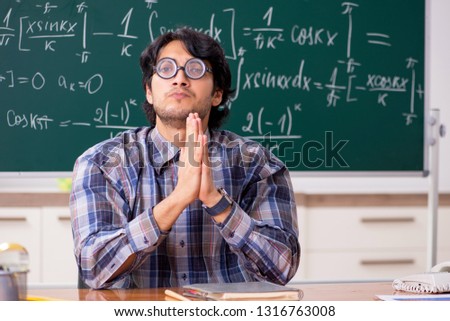 Funny male math teacher in the classroom