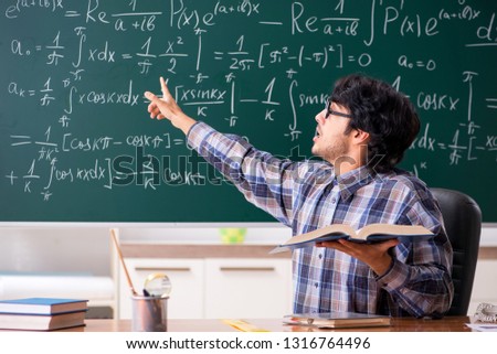 Funny male math teacher in the classroom
