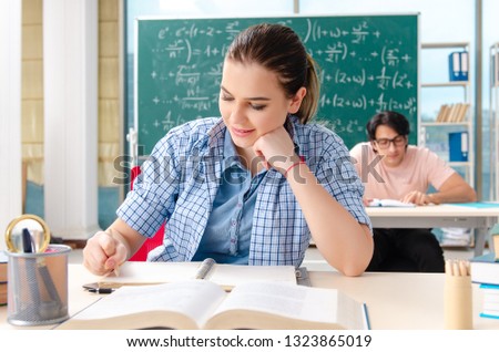 Young students taking the math exam in classroom