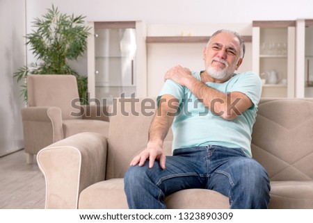 White bearded old man suffering at home