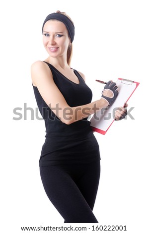 Young woman with notepad writing on white