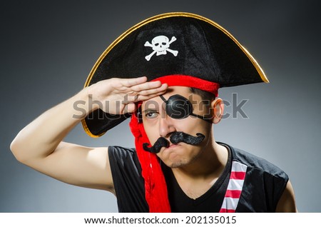 Funny pirate in the dark studio