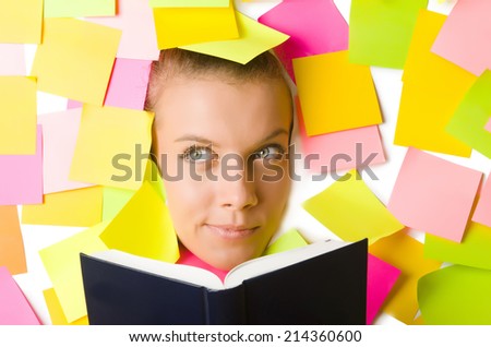 Woman with many reminder notes reading book