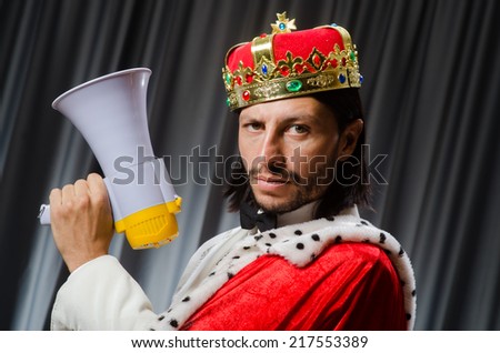 King with loudspeaker in funny concept