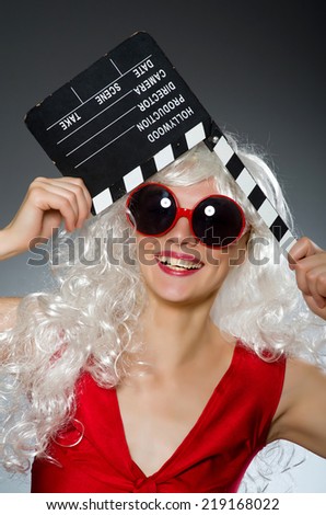 Blond woman with movie board