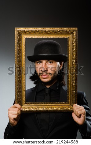 Man in topper hat and picture frame