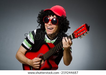 man with funny haircut and guitar