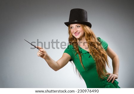 Woman magician wearing green dress