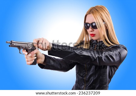 Woman in leather suit with handgun