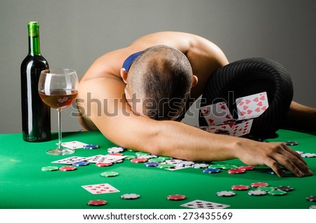 Man drinking and playing in casino