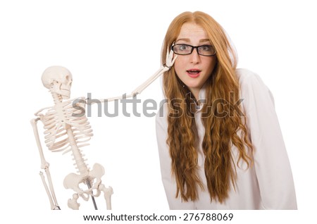 Young female doctor with skeleton isolated on white
