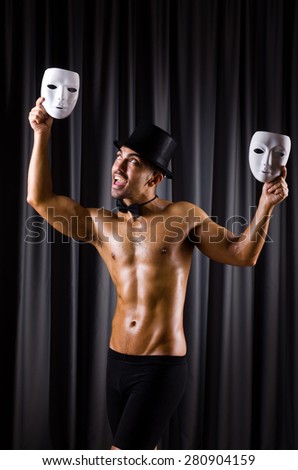 Muscular actor with theatrical mask