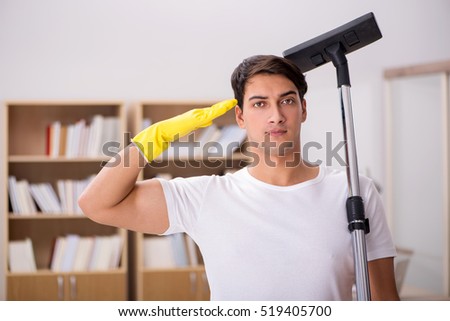 Man cleaning home with vacuum cleaner