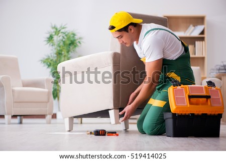 Furniture repairman repairing armchair at home