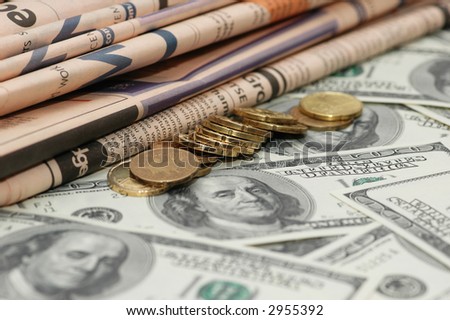 Business newspapers, coins and  dollar bank notes