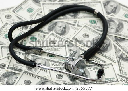 Medical concept -  stethoscope over the dollar bills