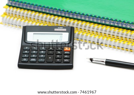 Calculator, spiral notebooks and pen isolated on white