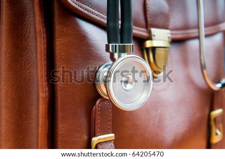 Doctor\'s case with stethoscope against wooden background