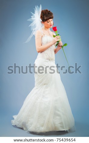 Beautiful bride with rose in studio shooting