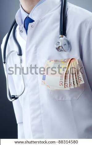Doctor with money in studio