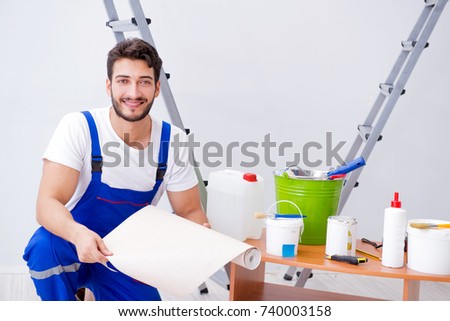 Repairman doing renovation repair in the house with paper wallpa