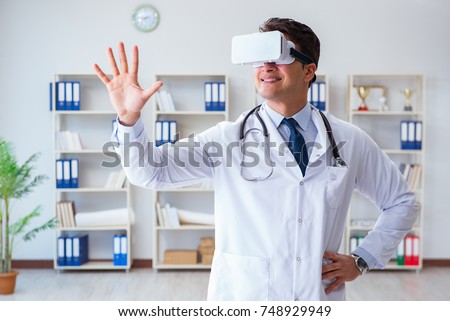 Young doctor with vr virtual reality headset working in the offi