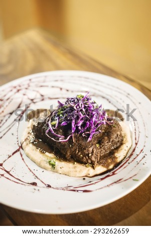 braised steak with mashed potato and red cabbage