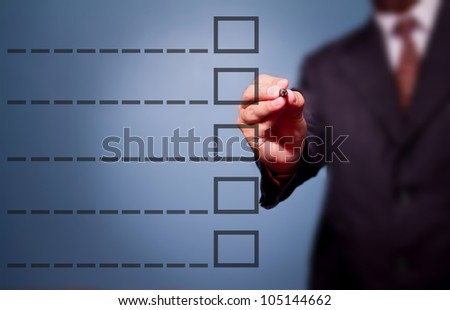 Young business man drawing a tick on a glass window in an office. Man choosing