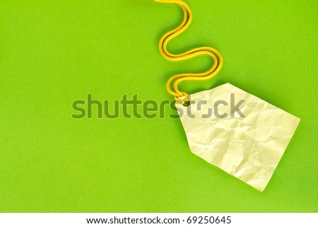 Blank yellow price tag isolated on green, Price tag, gift tag, sale tag, address label, etc.