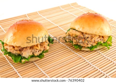 Two fresh burger with tuna on a mat