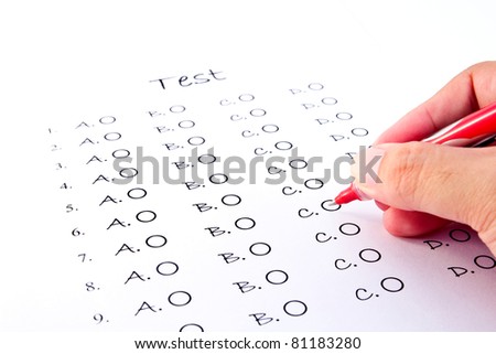 Hand on red pen choosing the test list on the examination